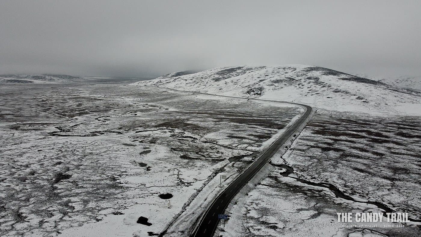 Deserted road on snowy Galitai Mountain Pass - China.
